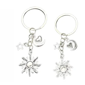 Front and back detail of celestial keychain with sun, moon heart, and star pendants