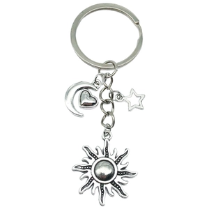 Silver metal keychain featuring celestial sun, moon, star, and heart charms on a ring