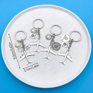 Detailed view of silver travel keychains with airplane charms and size measurements