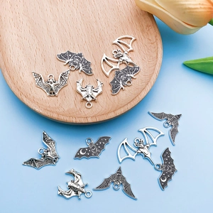 Macro view of assorted Gothic silver bat charms for DIY Halloween jewelry making