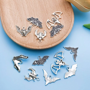 Detailed macro shot of vintage silver bat charms for Halloween DIY jewelry making