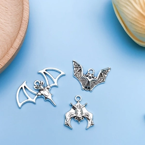 Macro shot of silver plated bat charms for DIY jewelry making in various bat wing styles
