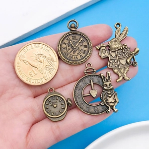 Detailed antique bronze Alice in Wonderland charms with a coin for size comparison