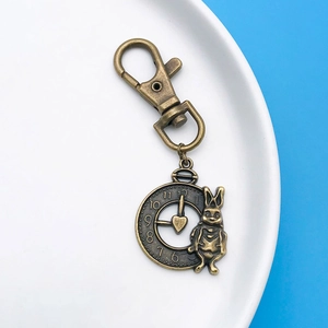 Detail view of Alice in Wonderland vintage bronze rabbit and pocket watch pendant charms