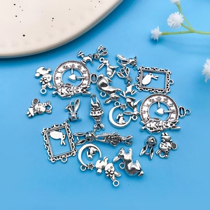 Detailed view of antique silver Alice in Wonderland charms including rabbits and clock