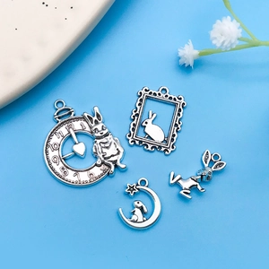 Detailed close-up of antique silver Alice in Wonderland rabbit charms for DIY jewelry making