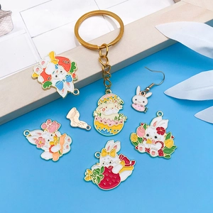 Detailed close-up of colorful Easter bunny charms with floral and carrot enamel details