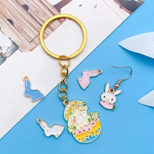 Close-up of Easter rabbit and carrot enamel charms with golden alloy keychain accessories