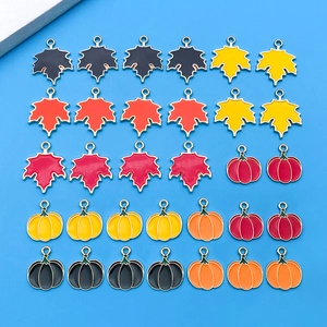 Enamel maple leaf and pumpkin pendant set for DIY jewelry making in autumn colors