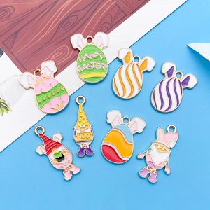 Detailed close-up of colorful enamel Easter charms with rabbit eggs and festive gnomes