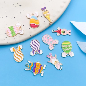 Macro detail of colorful enamel Easter bunny and egg charms with gold metal edges