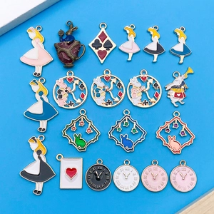 Detail of Alice in Wonderland themed enamel charms with rabbits and clocks on blue background