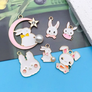 Detail showing various Easter bunny enamel charms with pearls and stars on gold plating