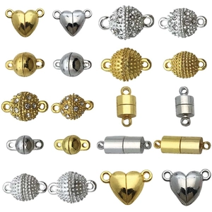 Assorted gold and silver magnetic jewelry clasps in heart, ball, and cylinder shapes