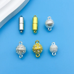 Detail of assorted silver and gold magnetic jewelry clasps with zircon inlays for DIY