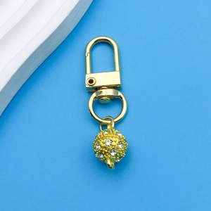 Detailed view of a golden spherical magnetic jewelry clasp set with sparkling rhinestones