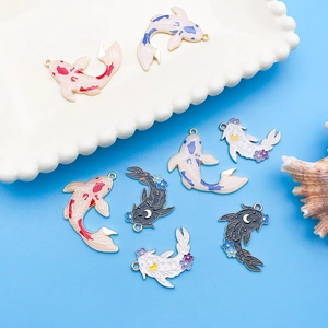 Detailed macro view of colorful enamel koi fish pendants for DIY jewelry making
