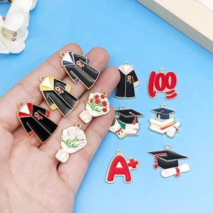 Enamel graduation charms set including graduation caps, diplomas, and floral pendants