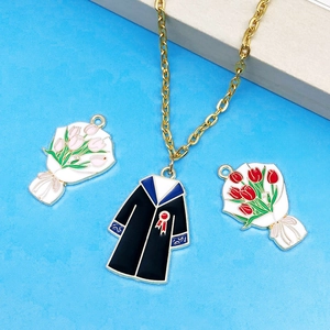 Graduation theme jewelry set featuring academic gown and tulip pendants on a gold chain