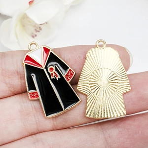 Detail of graduation gown pendant with black oil drip finish and golden metal texture