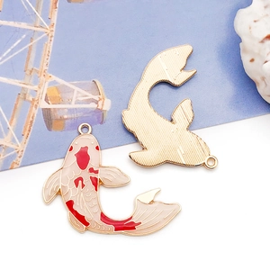 Detailed macro view of enamel koi fish charms with gold-plated finish and pink oil details