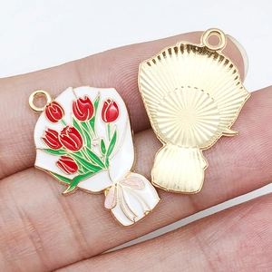 Detail view of tulip bouquet charms showing enamel finish and golden textured back