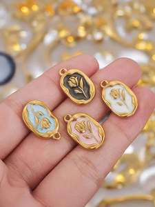 Detailed macro of vintage rose pendants in colorful enamel with golden finish