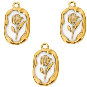 Detailed view of three vintage gold oval pendants with white enamel tulip flower accents