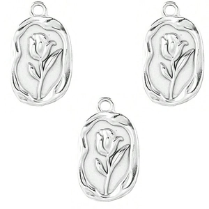 Detailed view of silver oval tulip relief charms for DIY jewelry making accessories