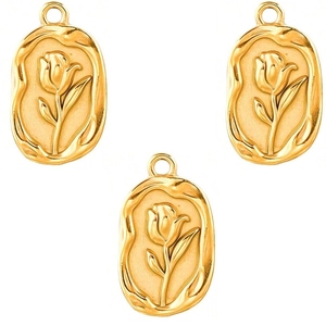 Detailed view of three golden oval tulip embossed pendants for jewelry making
