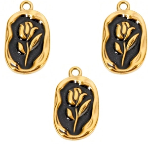 Detailed view of three vintage rose oval pendants with gold plating and black enamel