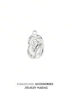 Detailed relief of a rose flower on a silver stainless steel oval pendant for DIY jewelry
