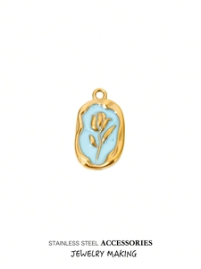 Detailed macro view of gold tulip relief on light blue enamel stainless steel pendant