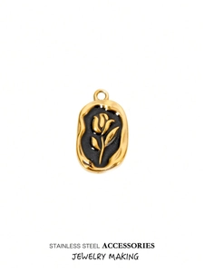Detailed macro view of vintage rose pendant with black enamel inlay on stainless steel