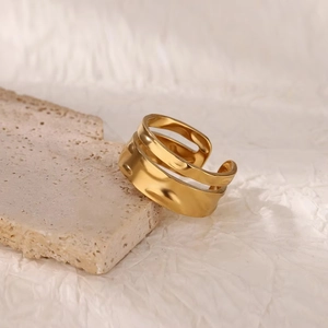 18K gold plated stainless steel double-layered open ring on beige stone background