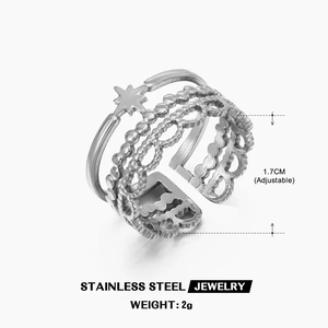 Macro detail of adjustable stainless steel ring with layered star and lace patterns