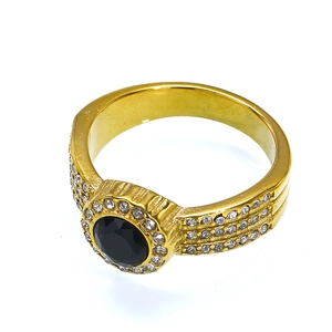 Macro shot of a luxury 18k gold-plated ring with black zircon center and pavé halo diamonds