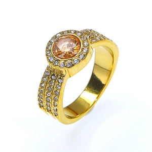 Detailed close-up of champagne zircon ring with white pave crystals and 18k gold plating