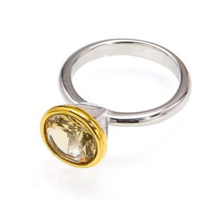 Macro view of dual-tone titanium ring with bezel-set large yellow round zircon