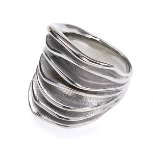 Macro shot of polished silver pleated titanium steel ring with stacked wave pattern