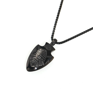Detail of vintage black Viking Odin arrow pendant with Valknut symbols and bead chain