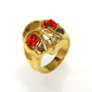 Gothic punk skull ring in gold plating with red rhinestone eyes and polished finish