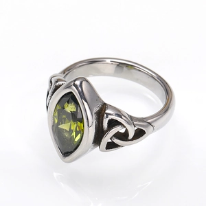 Detailed macro view of Marquise-cut olive green gemstone on Celtic knot silver ring