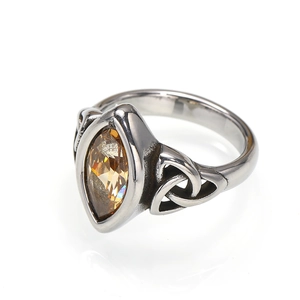 Detail of vintage marquise-cut amber stone ring with Celtic knot silver steel patterns