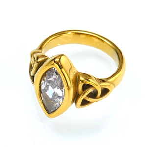Gold titanium ring with marquise-cut gemstone and Celtic knot cutouts on white background