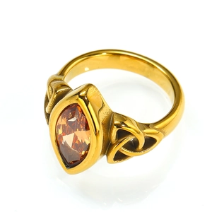 Detail of vintage gold ring featuring a brown marquise-cut gemstone and Celtic knots