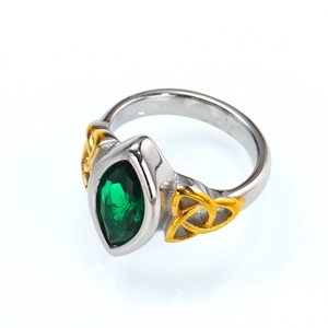 Detailed macro view of retro punk steel ring with green marquise stone and Celtic knots