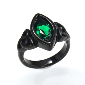 Close-up of vintage black titanium ring with marquise-cut green stone and Celtic knot detail
