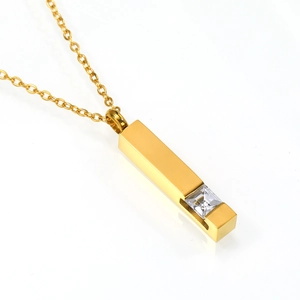 Macro shot of gold square pillar perfume bottle necklace with inlaid sparkling zircon