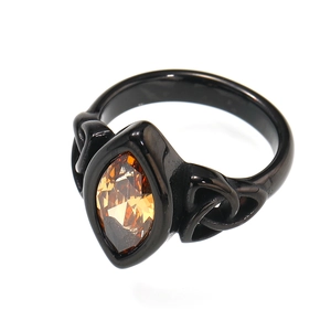 Detail of vintage punk titanium steel ring featuring marquise-cut orange gemstone